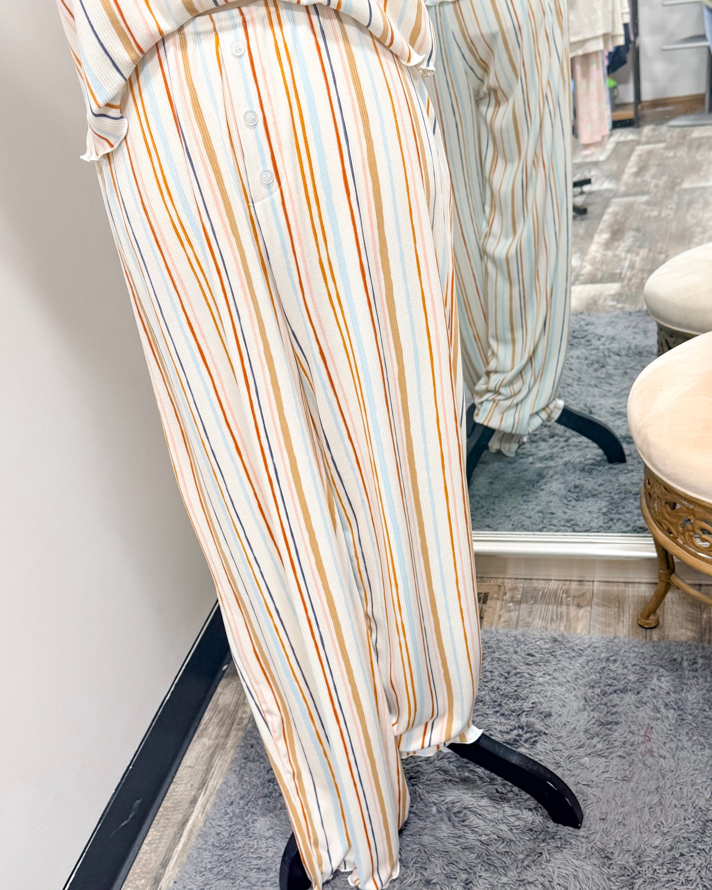 Striped pajama pants on a mannequin in front of a mirror