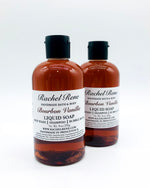 Two semi-transparent brown liquid soaps with white labels that read "Bourbon Vanilla." They have black pull top caps and sit on a white background.