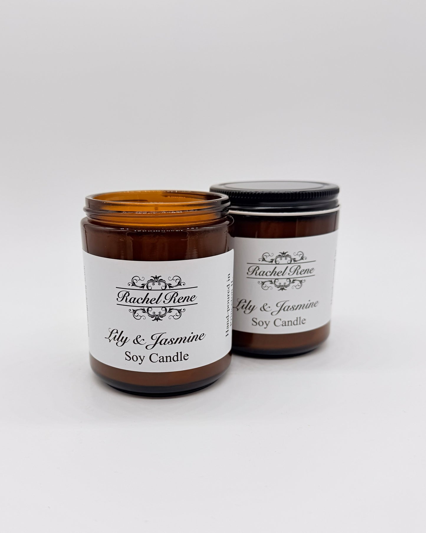 Two lily & jasmine soy candles with labels on a white background