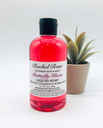 A semi-transparent pink liquid soap with a white label that reads "Rachel Rene: Handmade Bath & Body - Butterfly Kisses. Liquid Soap - Body Wash - Shampoo - Bubble Bath." It has a black pull top cap and sits on a white background.