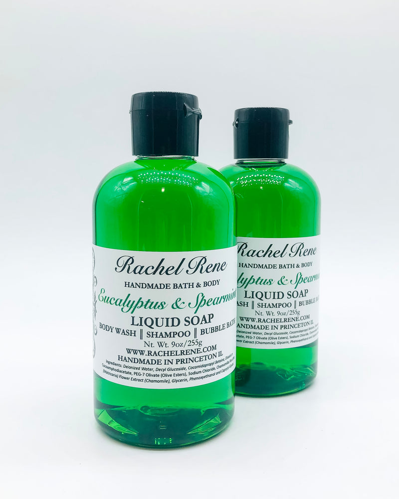 Two semi-transparent green liquid soaps with a white label that reads "Eucalyptus & Spearmint." They have a black pull top cap and sit on a white background.