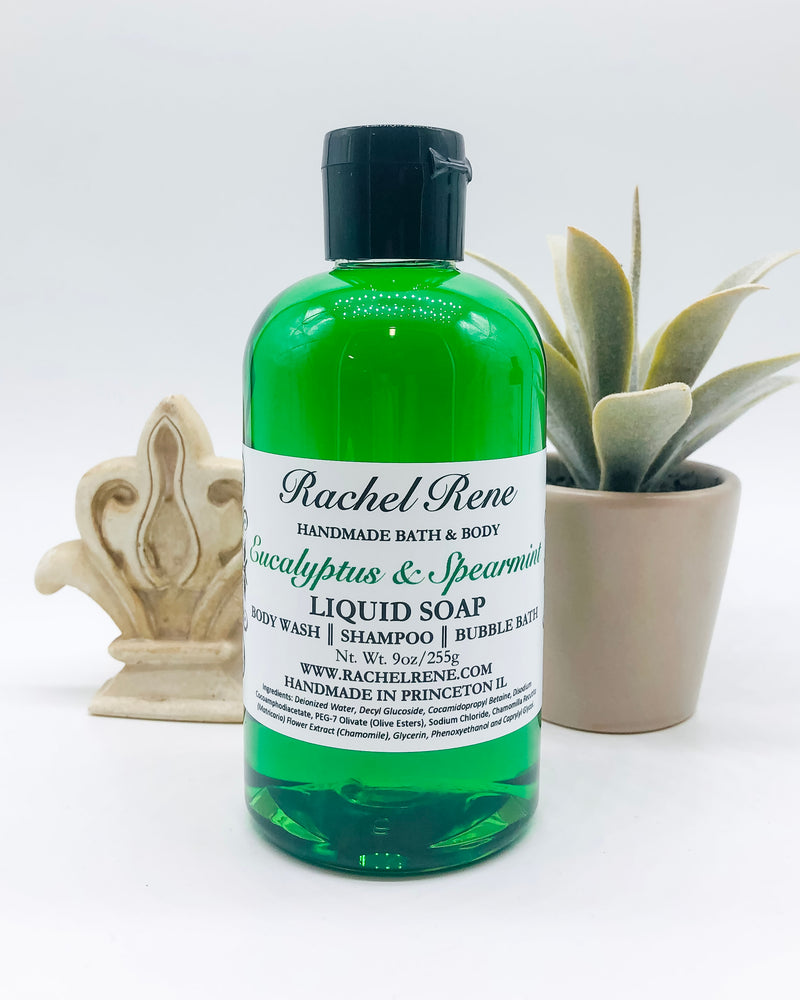 A semi-transparent green liquid soap with a white label that reads "Rachel Rene: Handmade Bath & Body - Eucalyptus & Spearmint. Liquid Soap - Body Wash - Shampoo - Bubble Bath." It has a black pull top cap and sits on a white background.