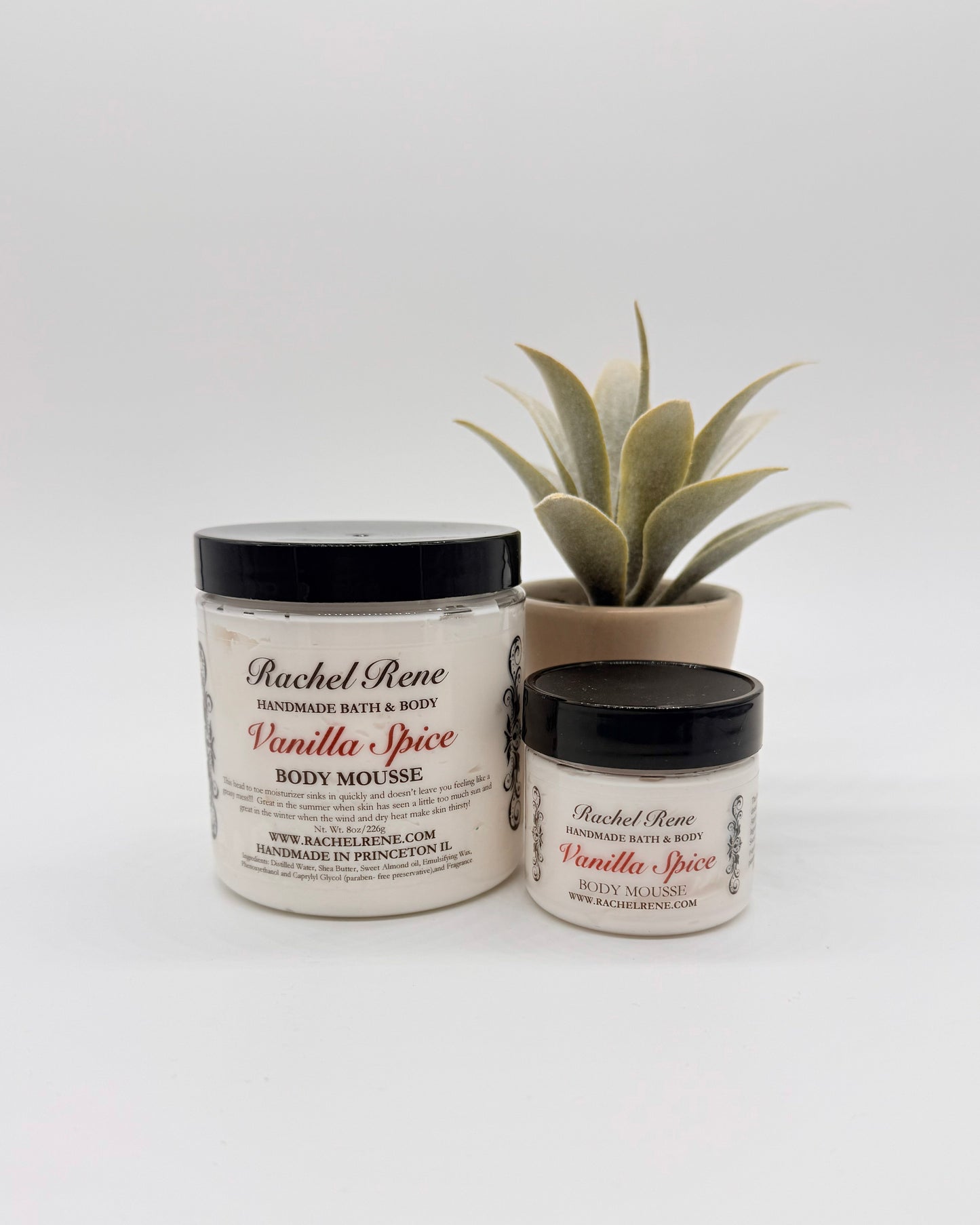 Two jars of Rachel Rene Vanilla Spice body mousse with a potted plant on a white background