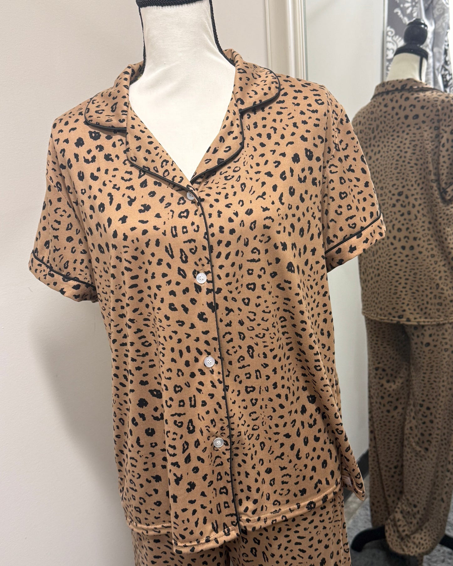 Leopard print pajama set on a mannequin against a plain background