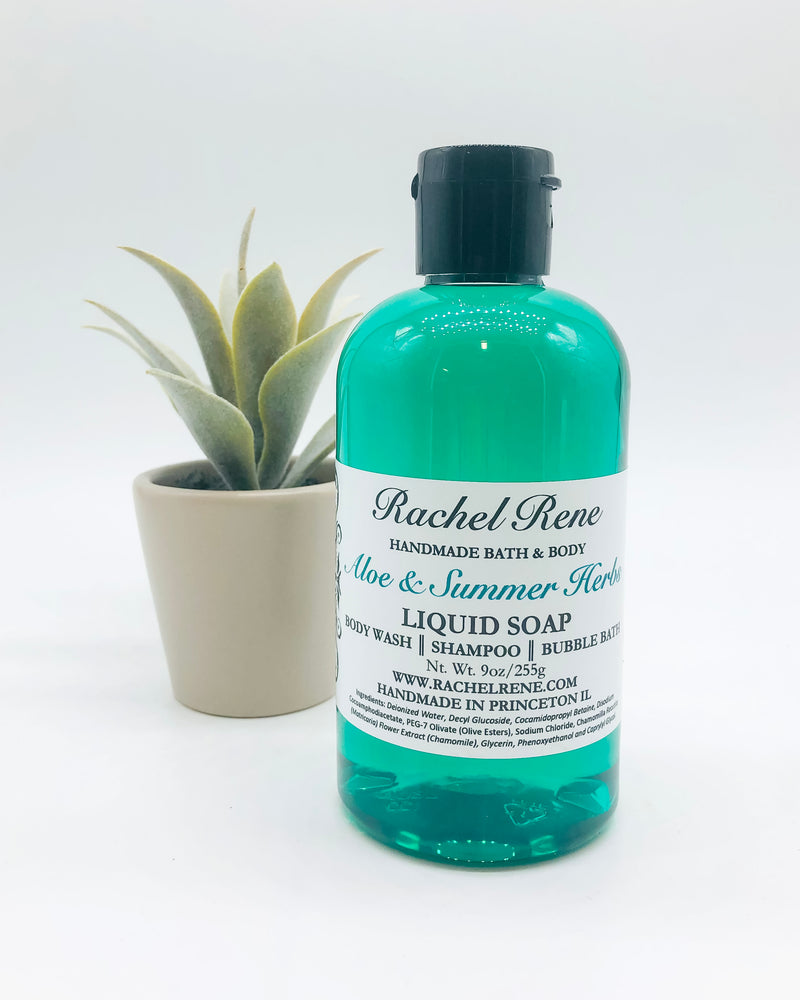 A semi-transparent teal liquid soap with a white label reading "Rachel Rene: Handmade Bath & Body - Aloe & Summer Herbs. Liquid Soap - Body Wash - Shampoo - Bubble Bath." It has a black pull-top cap and stands in front of a potted succulent and white background.