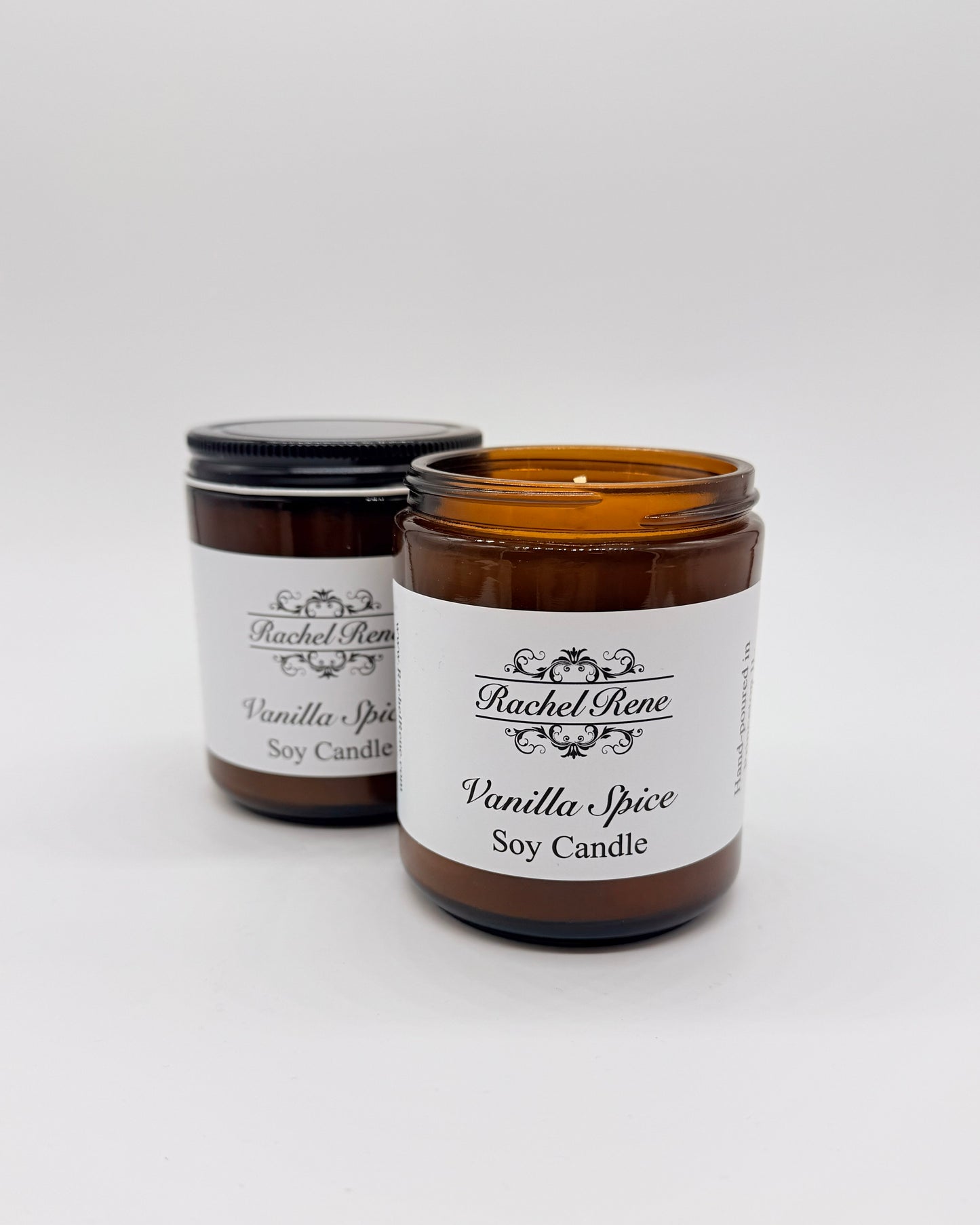 Two candles in amber jars labeled 'Vanilla Spice' by Rachel Rene on a white background