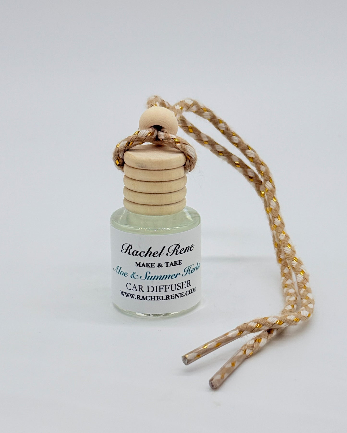 Car diffuser with wooden cap and cord on a white background