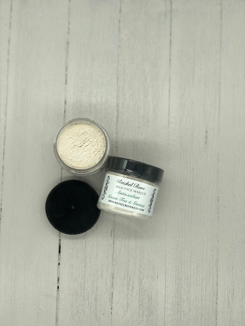 Light grey powder in a clear jar with a black lid labeled "Antioxidant Green Tea and Guava"