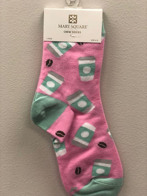 Pink crew socks with mint and white coffee cups and brown coffee beans.