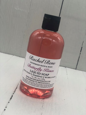 Pink semi-transparent liquid soap in a clear bottle with a black lid labeled "Butterfly Kisses"