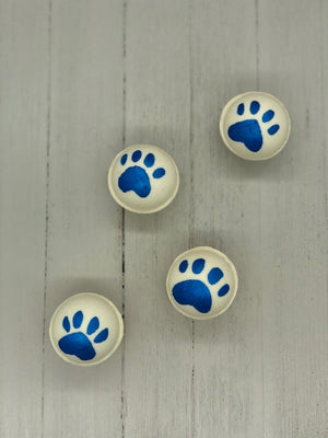 
            
                Load image into Gallery viewer, White bath bombs, some painted with blue paw prints, some painted with blue tiger stripes.
            
        