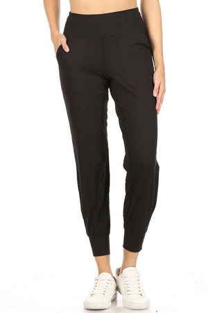 Black joggers. The bottoms are cinched to just above the ankle