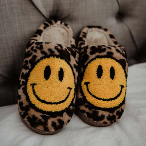 Leopard print slippers with yellow smiley faces.