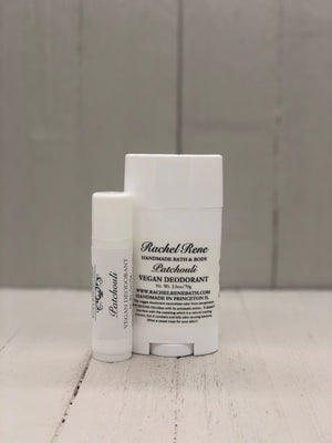 
            
                Load image into Gallery viewer, A white deodorant stick labeled &amp;quot;Patchouli&amp;quot; in gray letters.
            
        